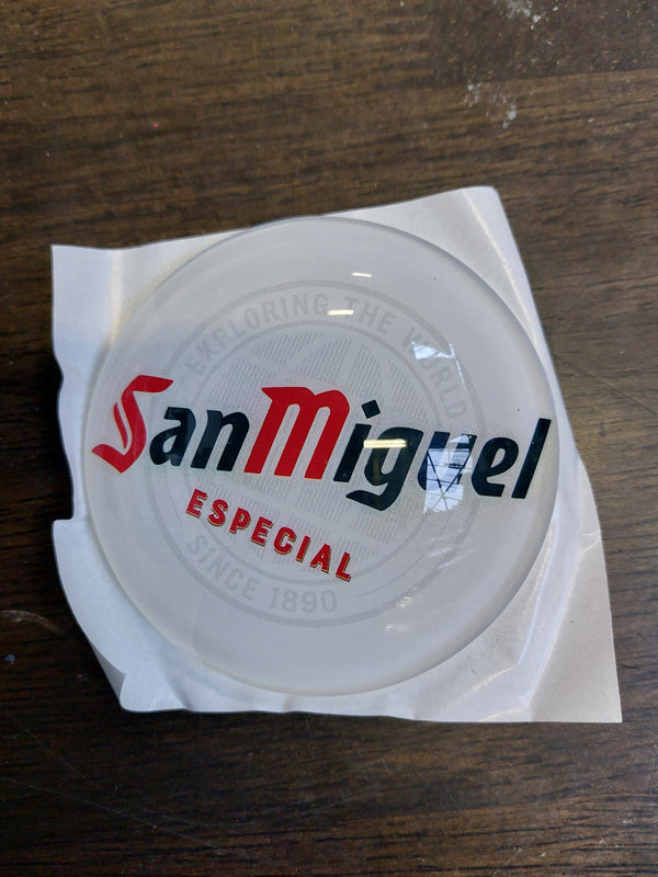San Miguel round badge