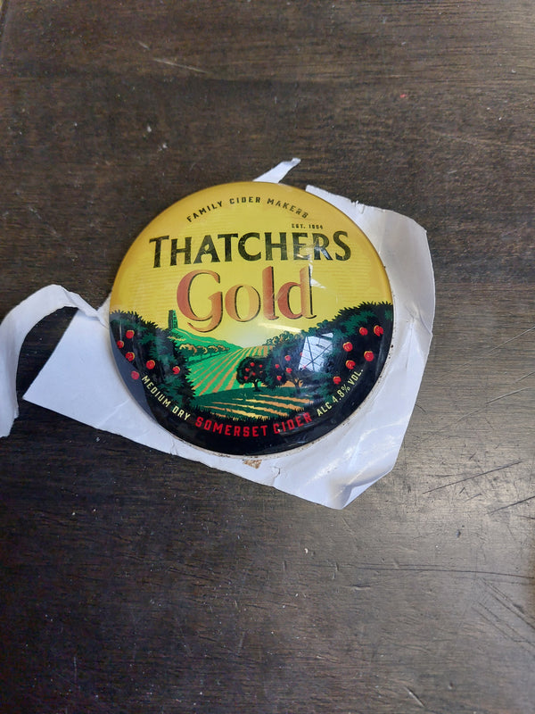 Thatchers gold round badge