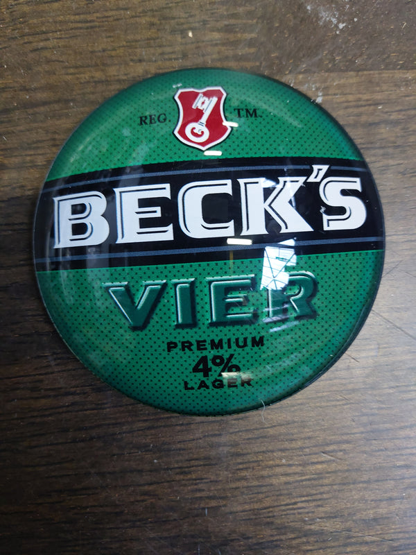 Becks vier round badge